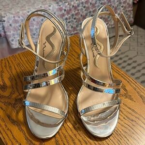 Nina silver “mirrored” Chelan heels.